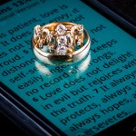 Image of wedding rings on phone showing 1Cor 13
